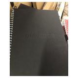 Large lot of black hard case notebooks with pen