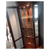Corner curio cabinet with four glass shelves and inside light