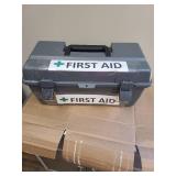 Plastic toolbox with first aid taped on it. Very few items inside.