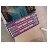 seven mixed books and a set of VHS