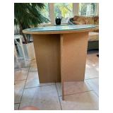 Particle board table - 28 inches tall - 29 inches across with glass top