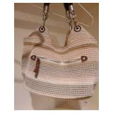 The Sak in neutral tones and a black woven bag