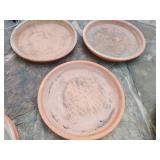 Assortment of clay saucers largest approx 18 inches in diameter smallest approx 5 inches in diameter