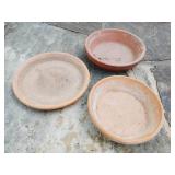 Assortment of clay saucers largest approx 18 inches in diameter smallest approx 5 inches in diameter