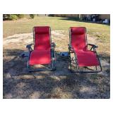 2 red zero gravity chairs with side table