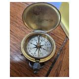 Five different kinds of compasses, one Bushnell, one older brass and two Lensatic Compass, liquid filled