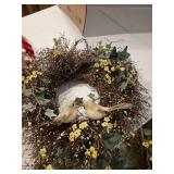 One patriotic wreath made from wood chips, and one bird themed spring wreath