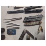 assorted pocket knives and tweezers