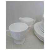 White on white floral set of dishes. 4 plates, 4 bowls, 4 saucers, 5 cups and a sugar creamer set