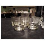 (5) drinking glasses and (4) vintage 3 footed sea shell.