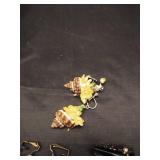 (1) Pair of sea shell clip on earrings and (2) Pairs of black gem clip on earrings.