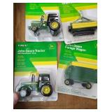 Four small John Deere toys