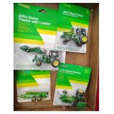 Four small John Deere toys