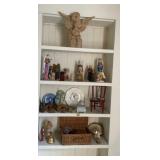 Contents on shelves, wooden cherub on top shelf ,