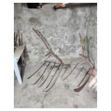 Two primitive green cradle scythes