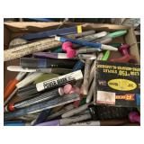 Group of sharpies staples and push pins