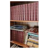 2 shelves of books including an antique guns book