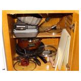 Contents of cabinet, baking pans, skillets,