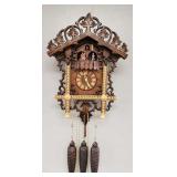 Ornately carved & inlaid wood figural cuckoo