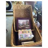 2 wicker baskets, Thomas Kinkade puzzle, photo albums