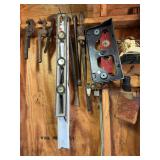 Items on wall: level weather station, crow bars, wrenches & other items