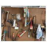 Items on pegboard: hammers, shears, paint brushes & miscellaneous tools & items above window by pegboard board