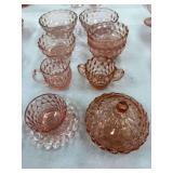 Pink depression glass bowls, creamer and sugar, cup and saucer, covered candy dish (some damage on one of the bowls)