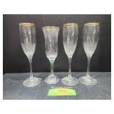 Four champagne flutes with bells on