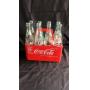 8 pack of coke bottles with plastic carrier