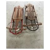 2 small wooden sleds