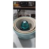 3 mixing bowls and green glass insulator