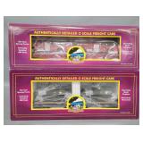 Two MTH premier O gauge flat cars with loads in original boxes