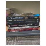 Assortment of Tabletop Wargame Books Including Shadowrun,Starfinder, and Warhammer