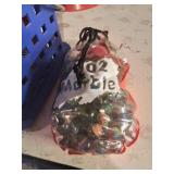 Container of many marbles including some shooters