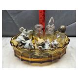 Vintage figurines and bottles in coin glass bowl