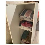 White cabinet full of towels