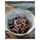 Galvanized pail of meat hooks