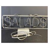 Neon hanging "salads" sign with Franceformer