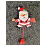 Pull string Santa pin.  Jumping bell ringer.