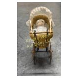 Vintage doll carriage with doll.