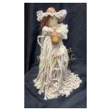 Yarn doll with stand.