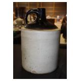 Brown and tan 2 gallon whiskey jug (chip on