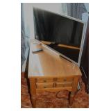 A Samsung Flat Panel TV and maple end table