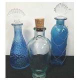 Three decorative bathroom glass bottles