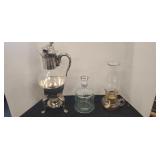 Hot beverage server, glass jug, and oil lamp.