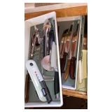 Drawer of large kitchen knives tongs can opener