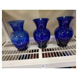 3 blue glass vases