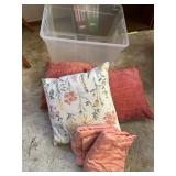 Tote of throw pillows and sheets