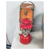 red Coleman lantern in wooden case