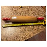 Red handled wooden rolling pin